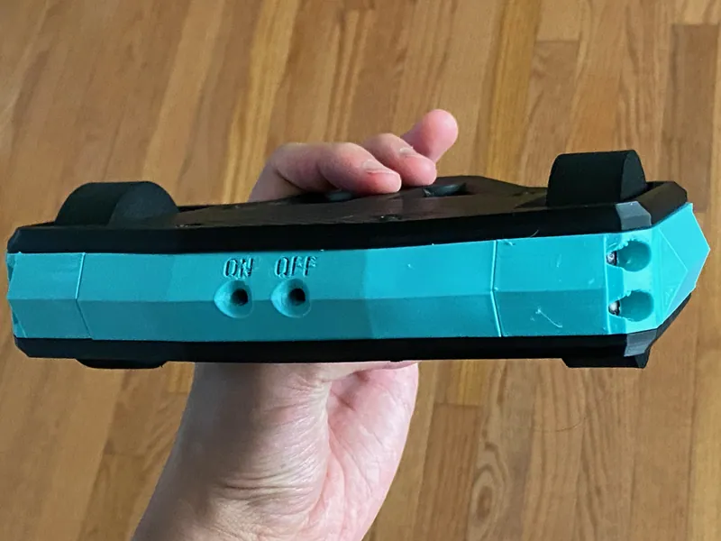The back of the frame: ON and OFF printed beside the two switch holes, and the wheels standing past the plates
