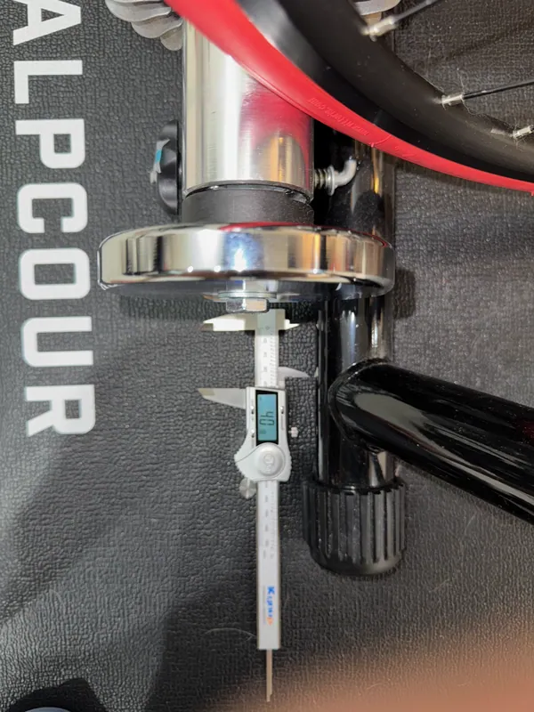 Calipers as a depth gauge, from the flywheel down to the trainer frame