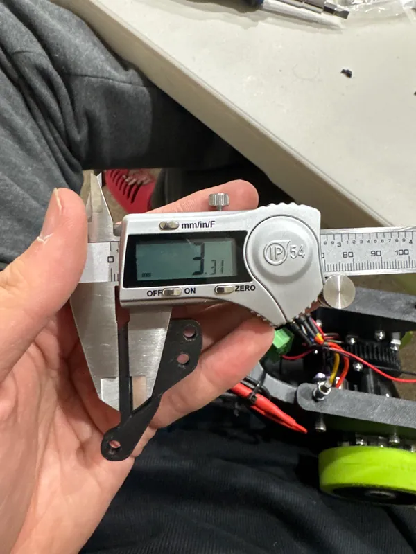 The caliper, with the printed link bar hanging from its jaw