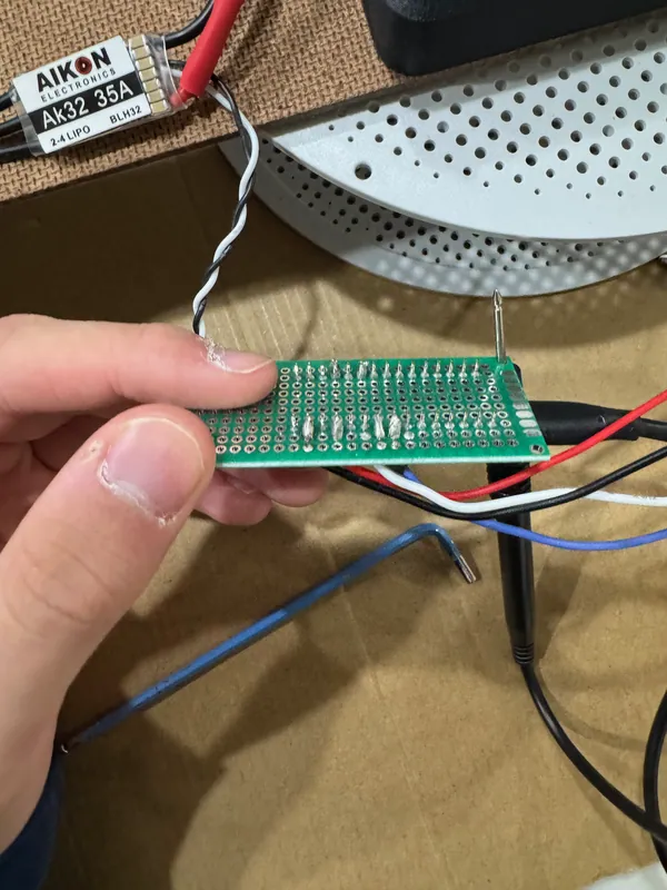 The AIKON AK32 35A ESC next to the perfboard