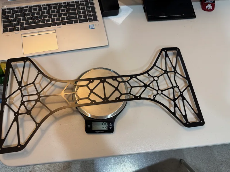 One G10 lattice plate on the same scale: 99 g