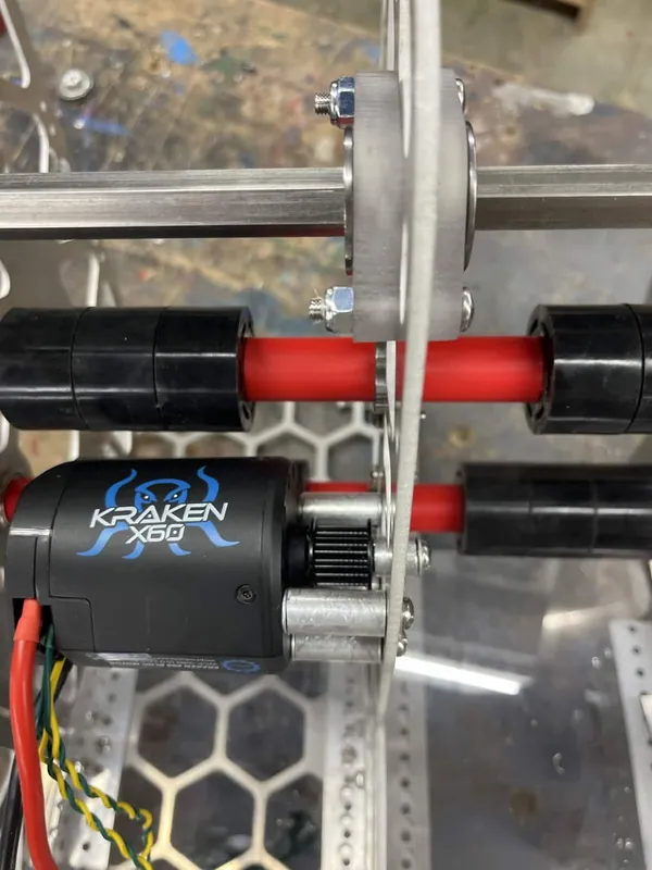 Early March: a Kraken X60 next to the flex-wheel transfer rollers on the real robot