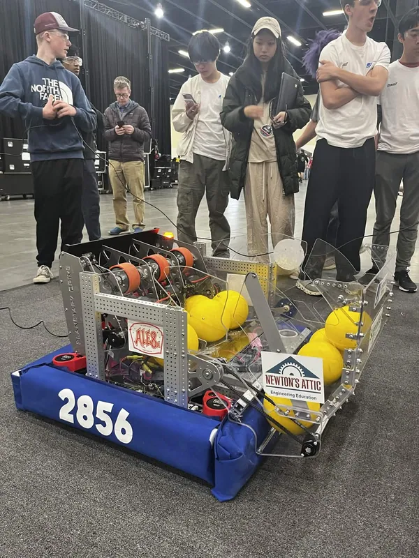 The finished robot at the regional, orange flywheels at the back and the hopper full of fuel