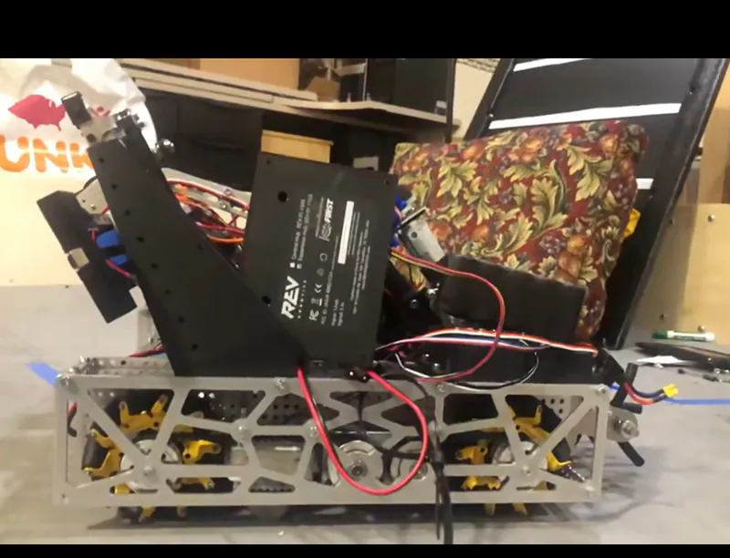 Jan 4, 2024: the side plate, lattice-cut aluminum with the mecanum wheels inside and a control hub on its printed tower