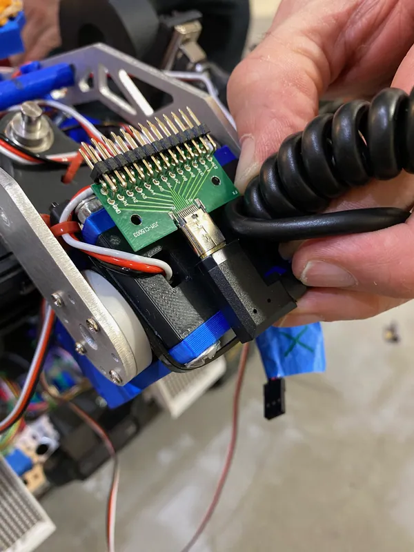 Jan 27, 2024: fitting the breakout board and coiled cable that carry the deposit's servo wiring up the lift