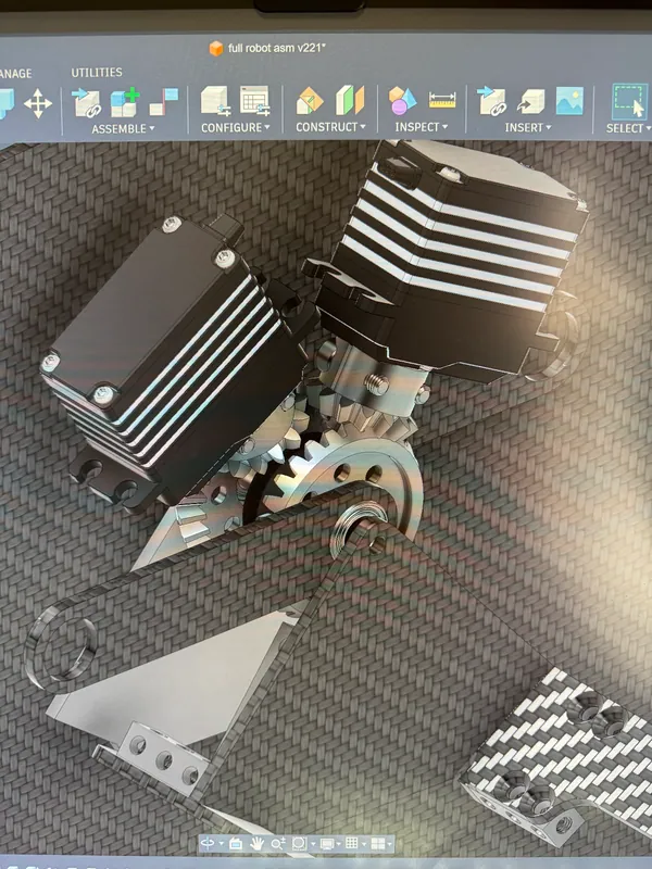 The turret drive in the CAD, March 30, 2026: two of the four Super Servos, their pinions in the ring gear
