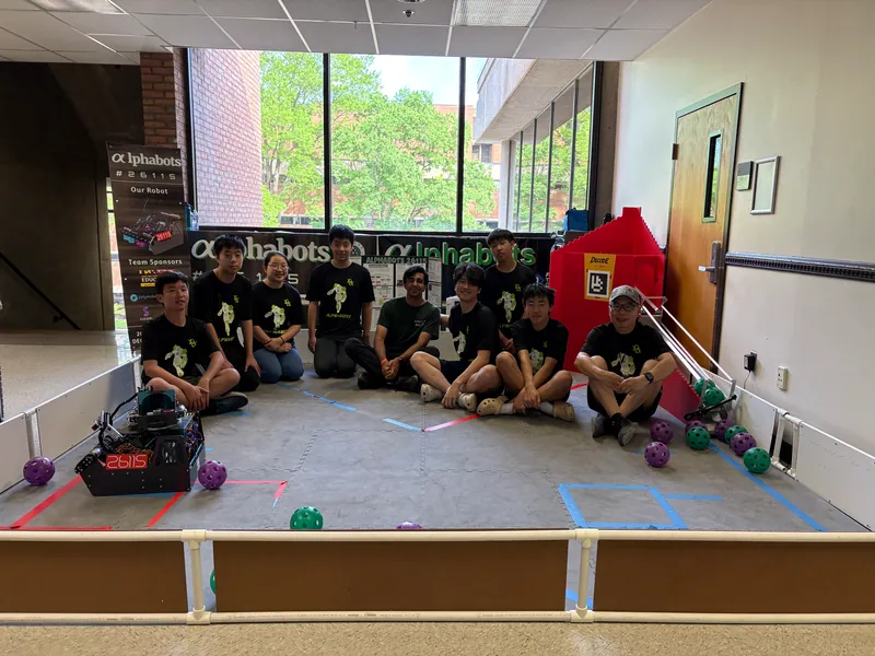 The team with the robot on our practice field, April 2026