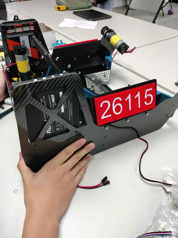 November 7: a carbon fiber side plate with its drive motor and number plate, before it went on the robot