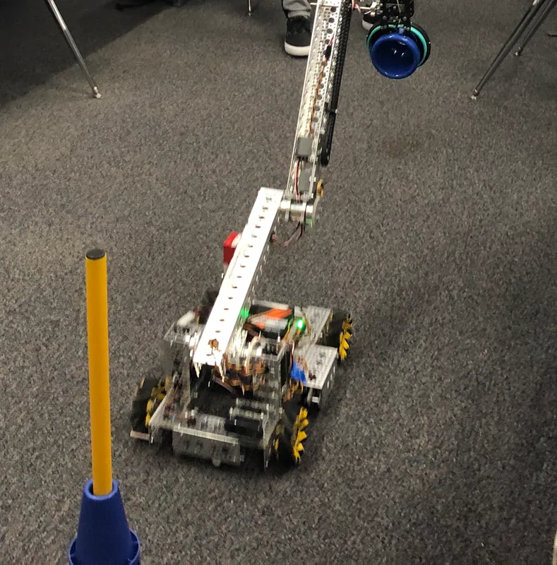February 2, 2023, a demo at school: both links nearly straight up, holding a blue cone high