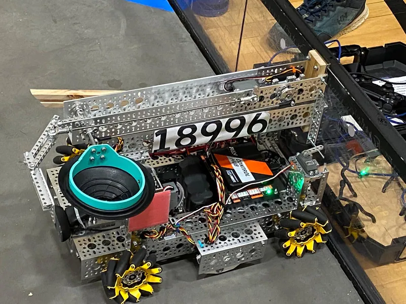 By Jan 4, 2023: the robot from above with the 18996 plate and the first claw, a black funnel with a teal ring, at the front corner