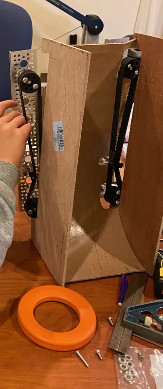 Day 11: a hardboard tower with timing belts up its walls