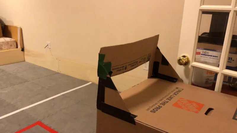 The goal: a Home Depot box with an opening cut in it, taped at the corners