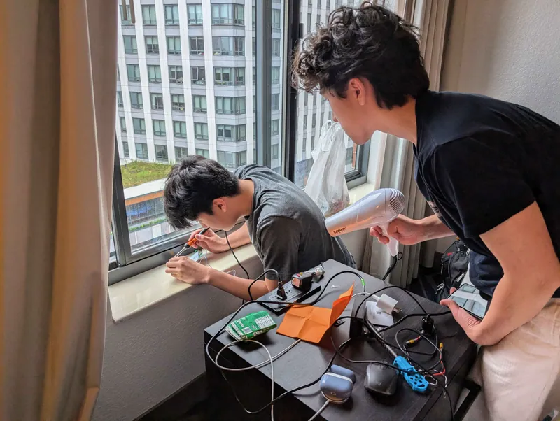 Jul 27: me soldering while my teammate and friend Ryker blows the solder fumes out the window with a hair dryer