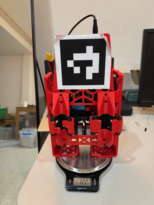 Weighing the rover, Aug 10: about 1.23 kg. Stood on end, it shows both latches: the left one’s cut doors overlap, the right one’s barely close