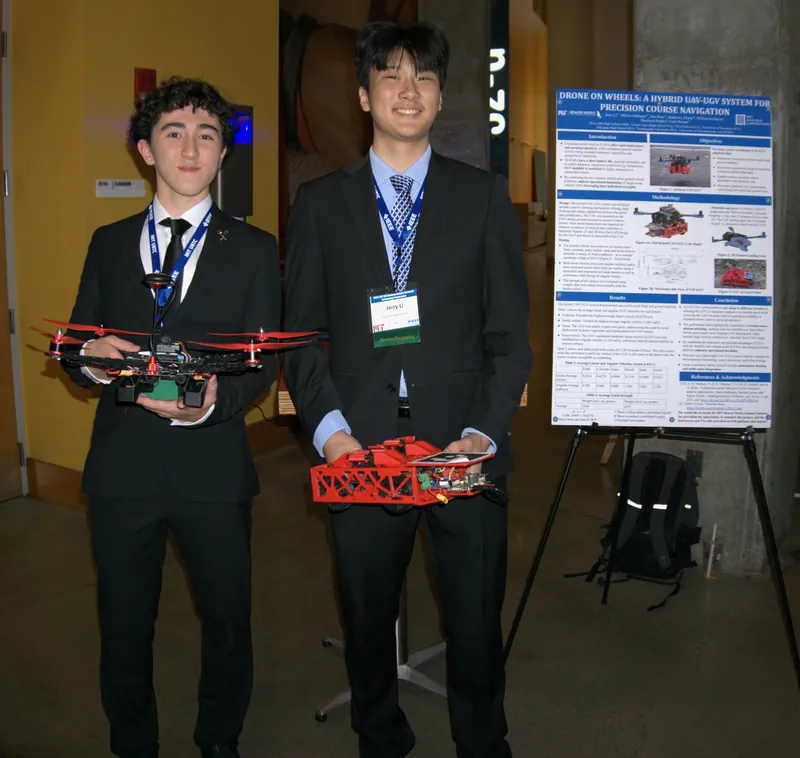 Ryker and me presenting the poster at URTC, with the drone and the rover undocked
