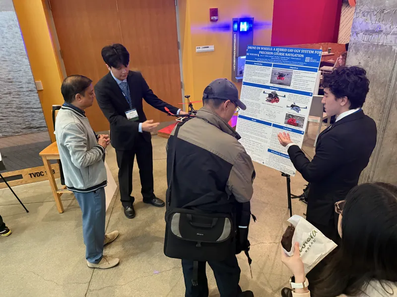Showing the vehicles to visitors at the poster session
