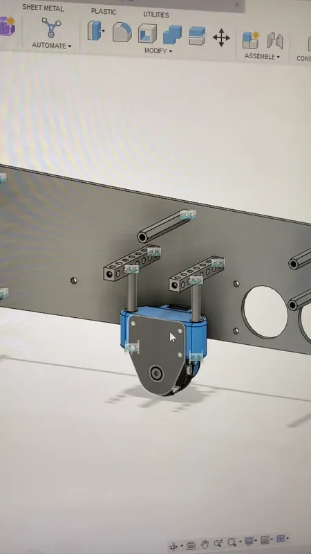 April 2023: the dead-wheel odometry pod (blue) hanging from the side plate