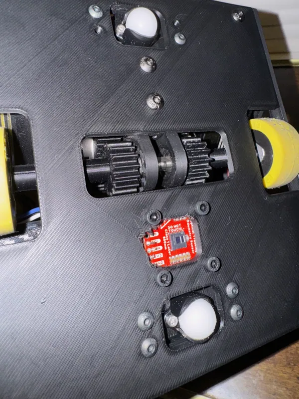 The underside: the red OTOS between the gears and the front caster